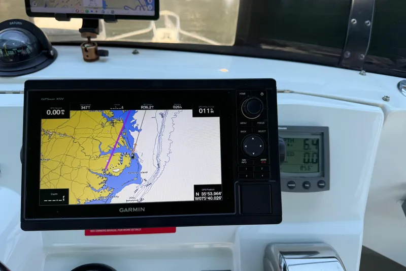 Slide: The Image of Garmin GPS navigation system on 2000 Mainship 390 Trawler boat dashboard. - 44