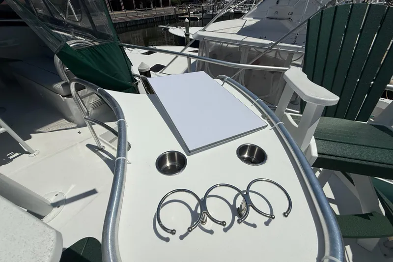 Slide: The Image of Deck of 2000 Mainship 390 Trawler with cup holders and seating area. - 33