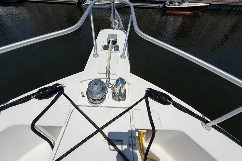 Slide: The Image of Bow view of 2000 Mainship 390 Trawler with anchor and railing. - 51