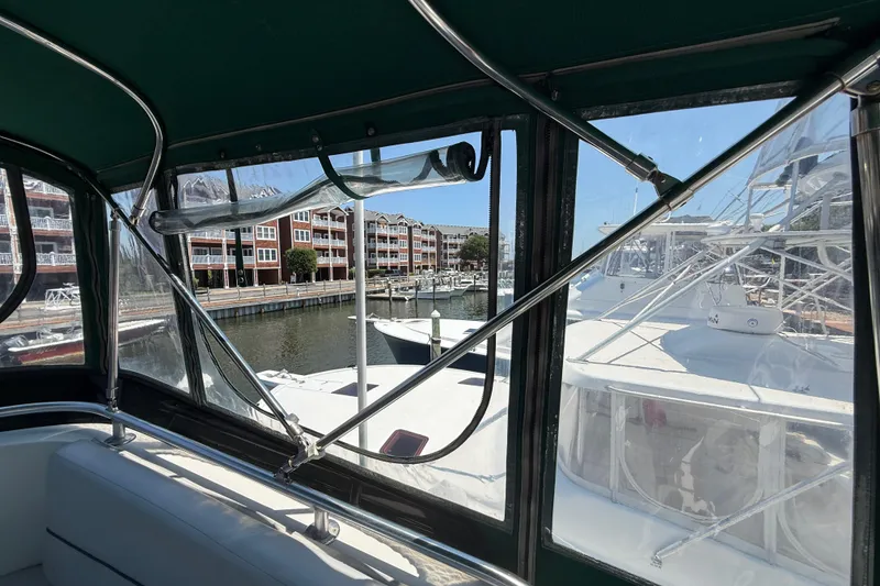 Slide: The Image of Interior view of 2000 Mainship 390 Trawler docked at marina with waterfront buildings. - 36