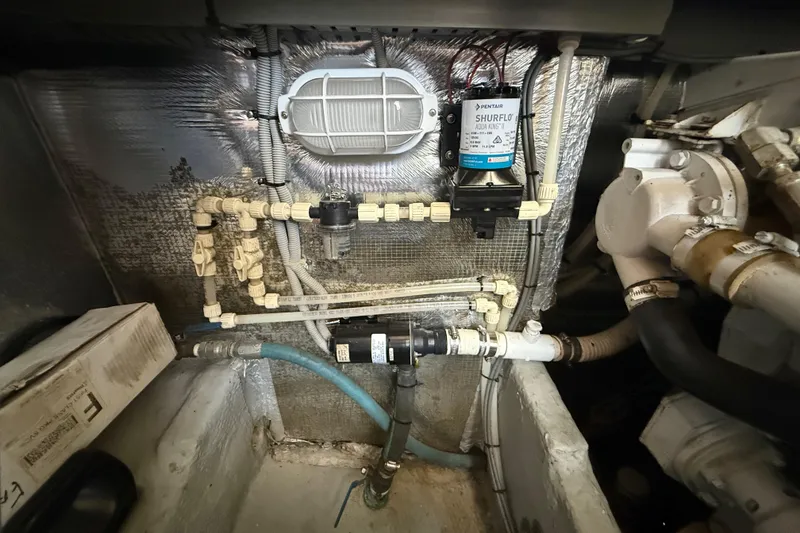 Slide: The Image of Engine room of 2000 Mainship 390 Trawler with plumbing and pump system. - 93
