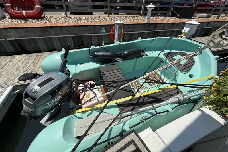 Slide: The Image of A 2000 Mainship 390 Trawler with Yamaha outboard motor docked at a marina. - 6