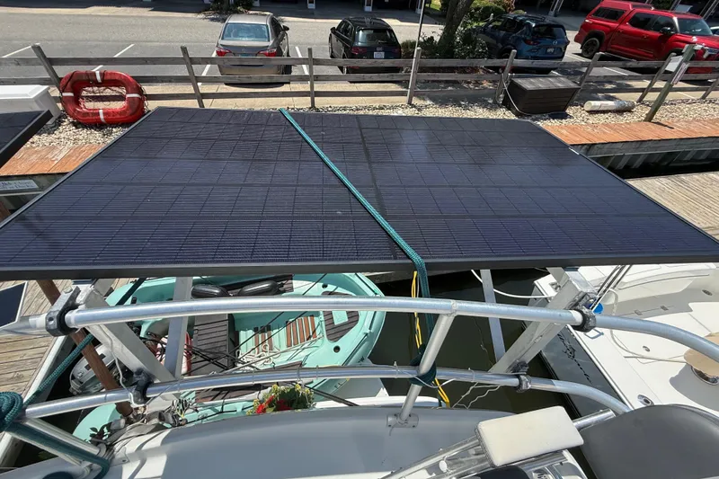 Slide: The Image of Solar panels on a 2000 Mainship 390 Trawler, docked at a marina. - 30