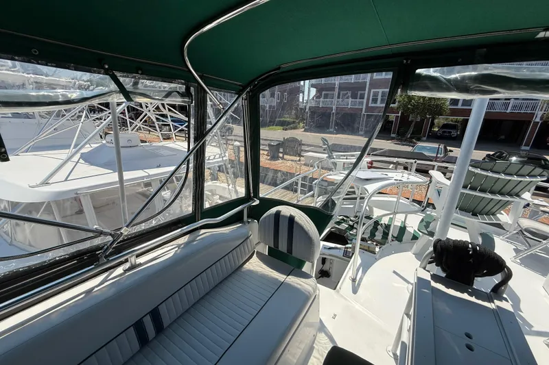 Slide: The Image of Interior view of 2000 Mainship 390 Trawler with green canopy and seating area. - 20