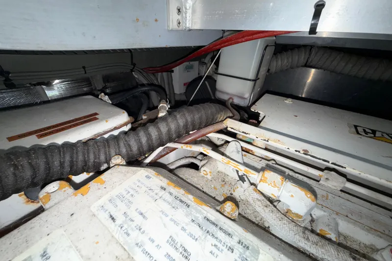 Slide: The Image of Engine compartment of a 2000 Mainship 390 Trawler, showing cables and components. - 90