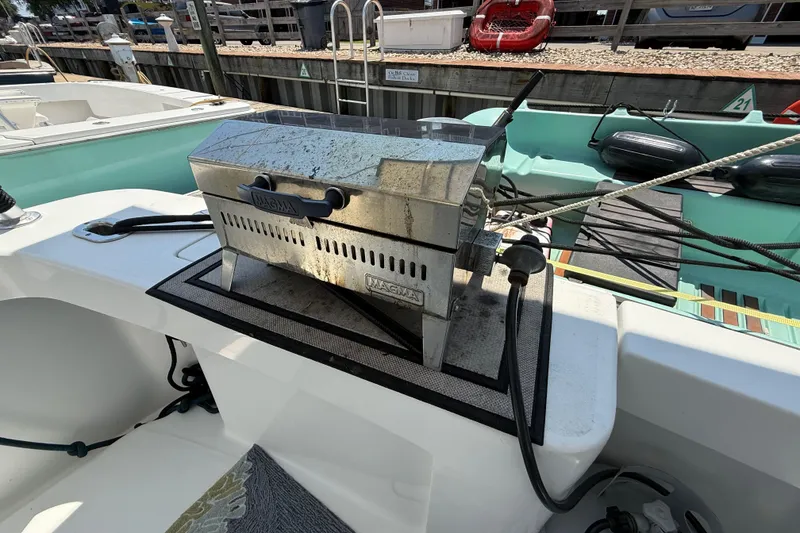 Slide: The Image of Outdoor grill on a 2000 Mainship 390 Trawler boat deck, docked at marina. - 12