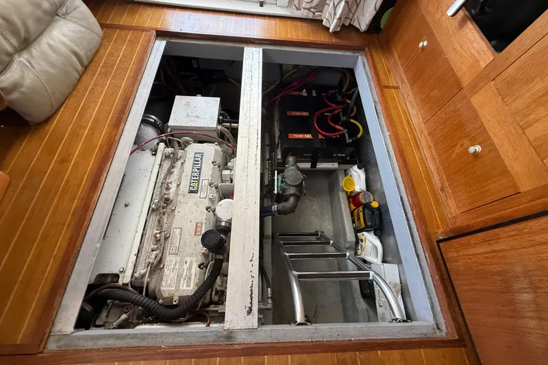 Slide: The Image of Engine compartment of 2000 Mainship 390 Trawler with Caterpillar engine and batteries. - 79