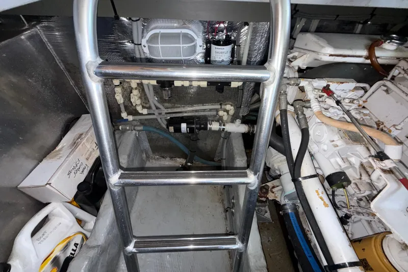 Slide: The Image of Engine room of 2000 Mainship 390 Trawler with ladder and mechanical components. - 81