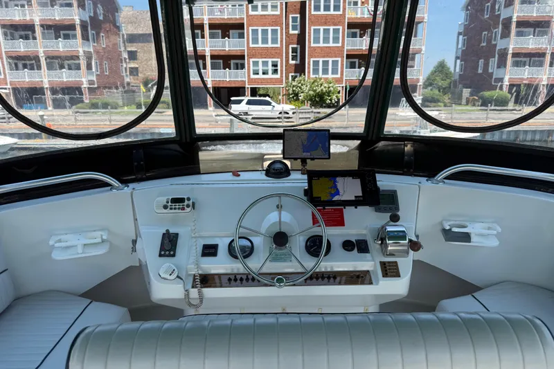 Slide: The Image of Cockpit of 2000 Mainship 390 Trawler with navigation equipment and waterfront view. - 45