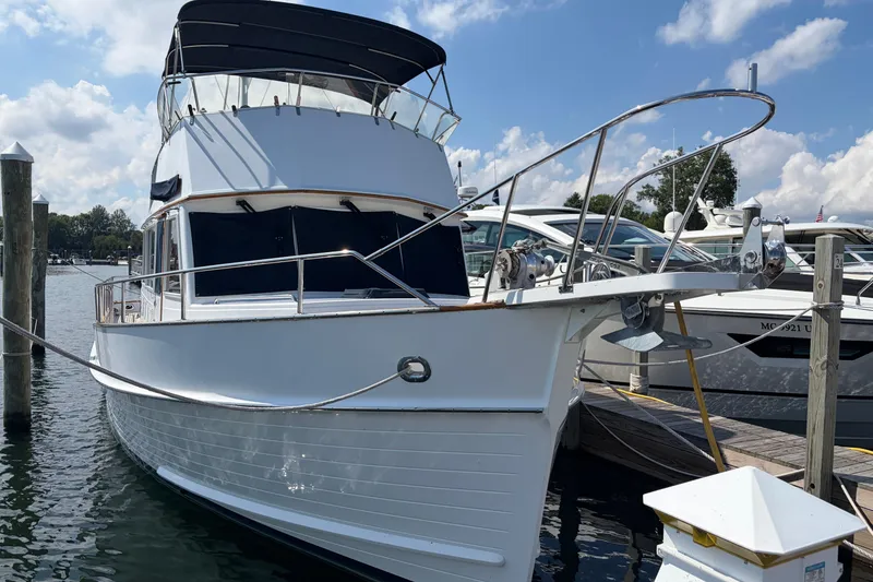 Slide: The Image of Grand Banks 42 Classic 2001 yacht docked at marina under blue sky. - 2