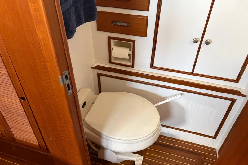 Slide: The Image of Grand Banks 42 Classic 2001 yacht bathroom with wooden cabinetry and marine toilet. - 21