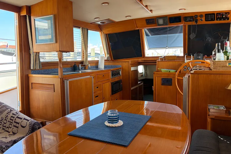 Slide: The Image of Interior of a 2001 Grand Banks 42 Classic yacht with wooden finishes and nautical decor. - 6