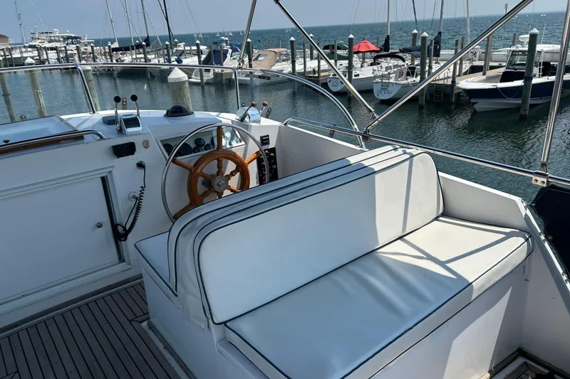 Slide: The Image of Helm of 2001 Grand Banks 42 Classic yacht with marina view. - 9