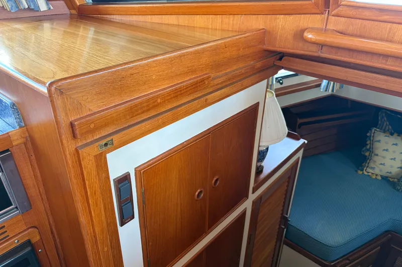 Slide: The Image of Interior of 2001 Grand Banks 42 Classic yacht with wooden cabinetry and cozy seating area. - 24