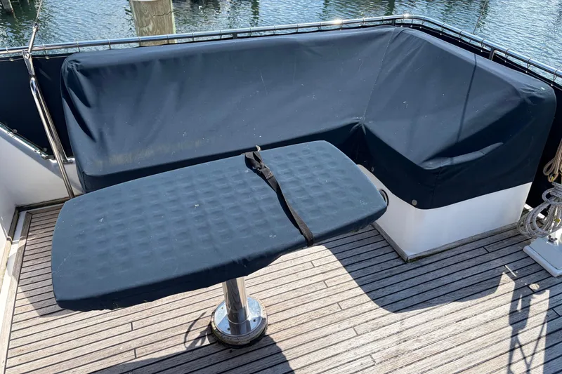 Slide: The Image of Deck seating area on a 2001 Grand Banks 42 Classic yacht with blue covers. - 31