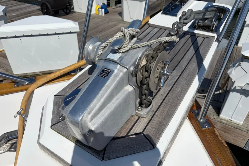 Slide: The Image of Anchor windlass on 2001 Grand Banks 42 Classic yacht deck, featuring polished metal and wood accents. - 34