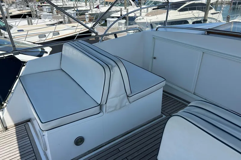 Slide: The Image of Grand Banks 42 Classic 2001 yacht seating area with white cushions at marina. - 8