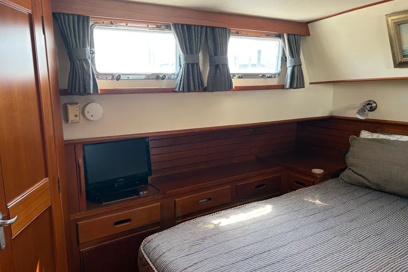 Slide: The Image of Cozy cabin interior of 2001 Grand Banks 42 Classic yacht with wood paneling and small TV. - 17