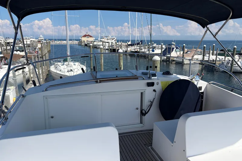 Slide: The Image of Flybridge view of a 2001 Grand Banks 42 Classic yacht docked at a marina. - 32
