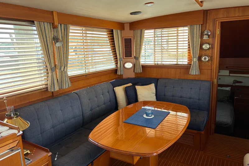 Slide: The Image of Interior of 2001 Grand Banks 42 Classic yacht with elegant wood finish and cozy seating area. - 5