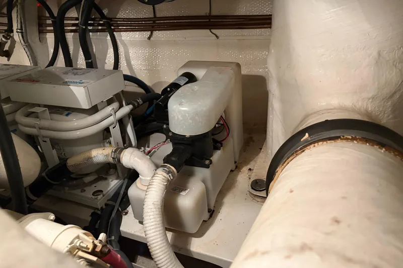 Slide: The Image of Engine room of 2001 Grand Banks 42 Classic yacht, showcasing mechanical components and piping. - 39