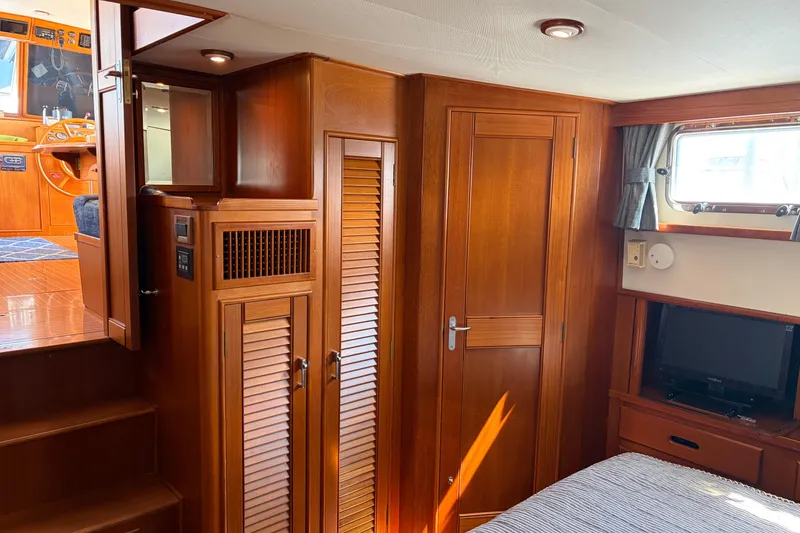 Slide: The Image of Interior of 2001 Grand Banks 42 Classic yacht with wooden cabinetry and cozy furnishings. - 18