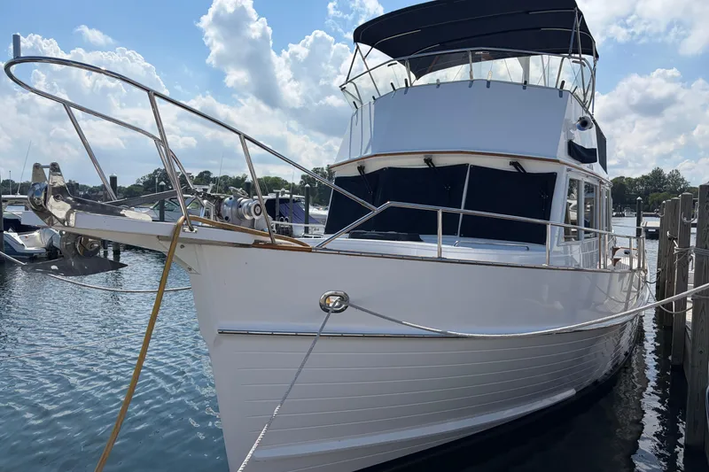 Slide: The Image of 2001 Grand Banks 42 Classic yacht docked at marina under blue sky. - 1
