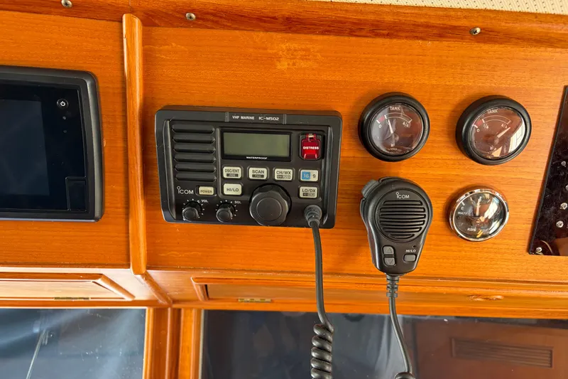 Slide: The Image of Control panel of a 2001 Grand Banks 42 Classic yacht with radio and gauges. - 12