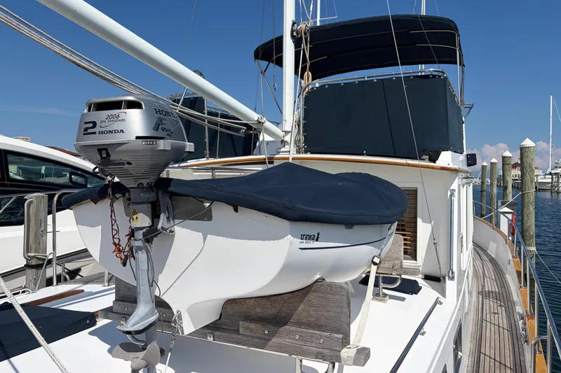 Slide: The Image of Grand Banks 42 Classic yacht with Honda outboard motor, docked at marina, 2001 model. - 4