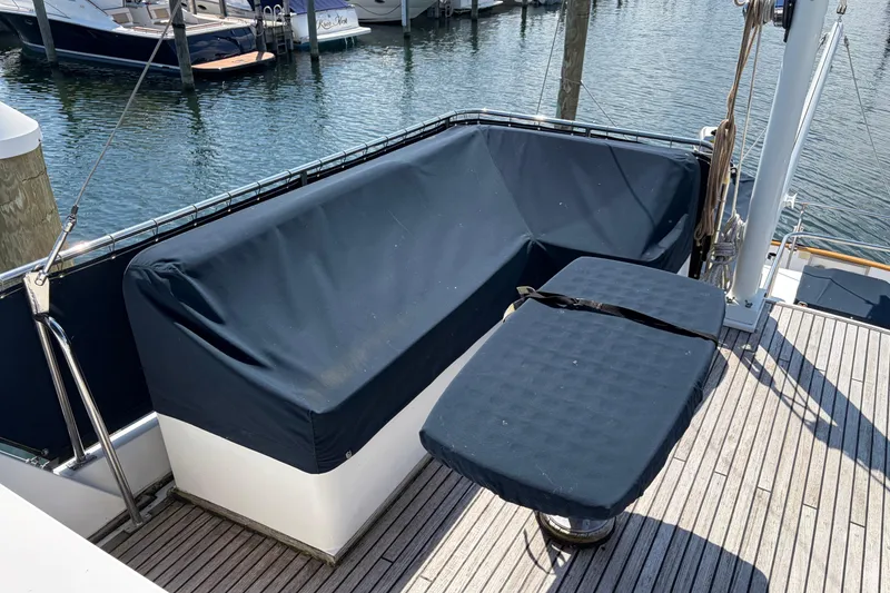Slide: The Image of Deck seating area on a 2001 Grand Banks 42 Classic yacht, featuring covered cushions. - 30