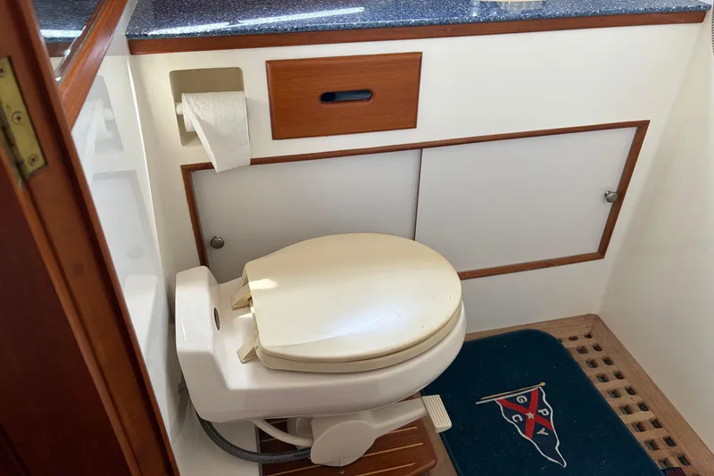 Slide: The Image of Bathroom interior of 2001 Grand Banks 42 Classic yacht, featuring a compact toilet setup. - 27