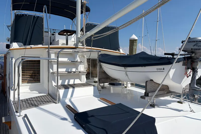 Slide: The Image of 2001 Grand Banks 42 Classic yacht deck with dinghy and Honda outboard motor. - 33
