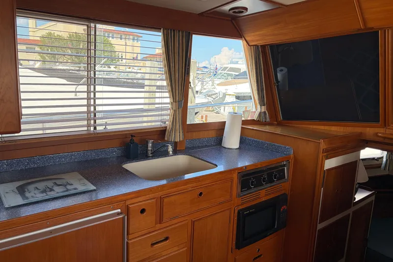 Slide: The Image of Interior of 2001 Grand Banks 42 Classic yacht kitchen with wooden cabinetry and modern appliances. - 7