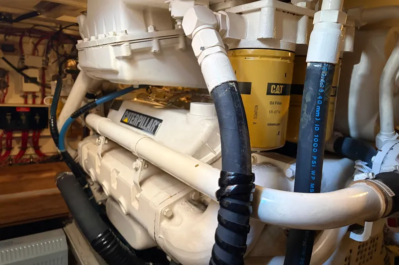 Slide: The Image of Engine room of 2001 Grand Banks 42 Classic with Caterpillar components and hoses. - 36