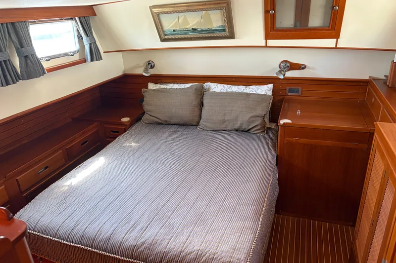 Slide: The Image of Cozy cabin interior of 2001 Grand Banks 42 Classic yacht with wooden furnishings and bed. - 16