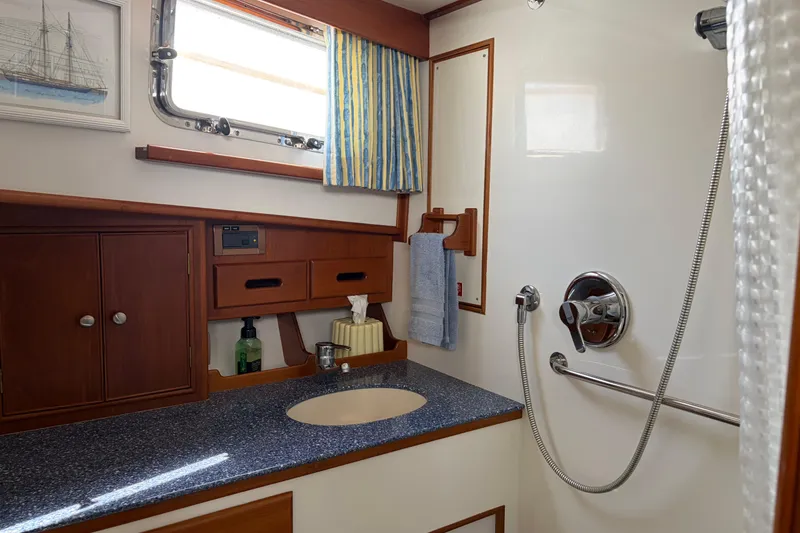 Slide: The Image of Bathroom interior of 2001 Grand Banks 42 Classic yacht, featuring wooden cabinetry and modern fixtures. - 26