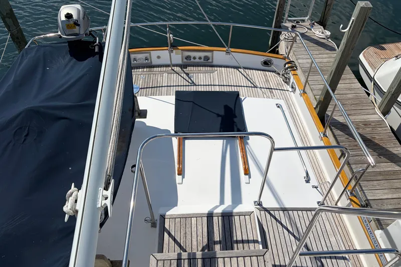 Slide: The Image of Grand Banks 42 Classic yacht deck, 2001 model, docked at marina with wooden flooring. - 29
