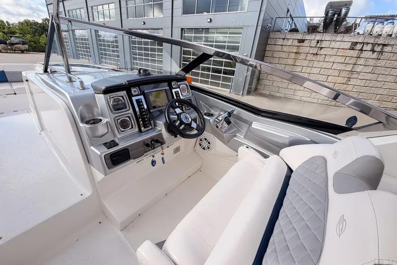Slide: The Image of 2012 Chaparral 327 SSX boat cockpit with modern controls and plush seating. - 24
