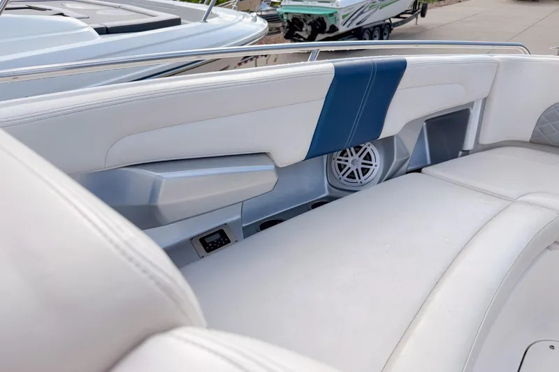 Slide: The Image of Interior of 2012 Chaparral 327 SSX boat with white seating and speaker system. - 18