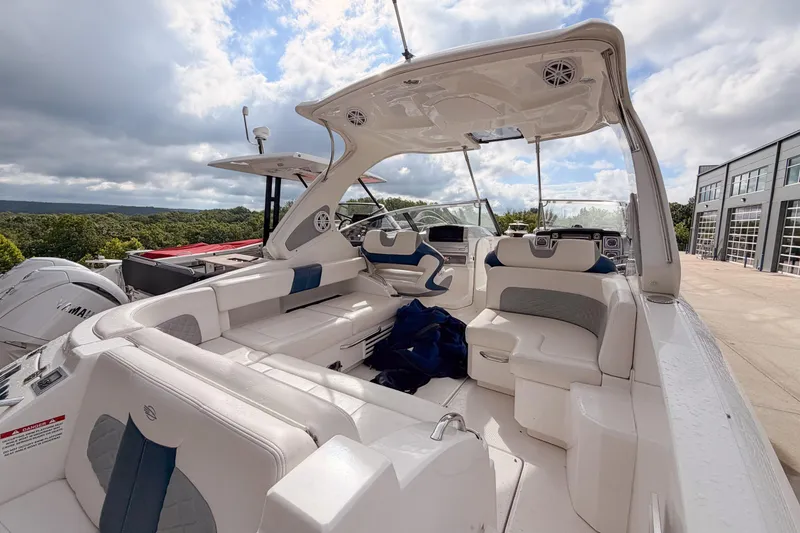 Slide: The Image of 2012 Chaparral 327 SSX boat interior with white seating and modern dashboard. - 8