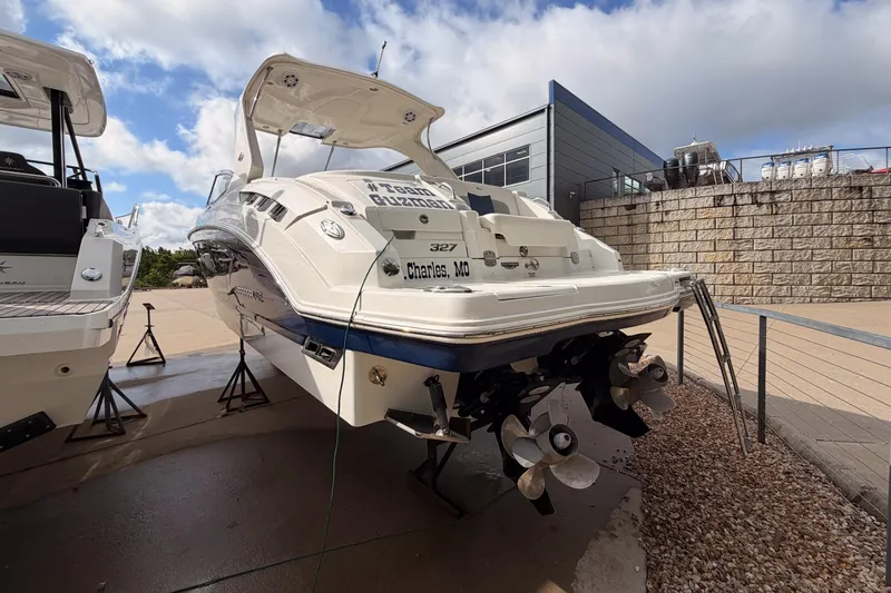 Slide: The Image of 2012 Chaparral 327 SSX boat on display, showcasing rear view and dual propellers. - 6