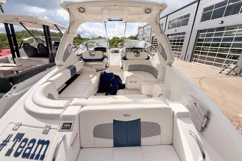 Slide: The Image of 2012 Chaparral 327 SSX boat interior with white seating and modern dashboard. - 7
