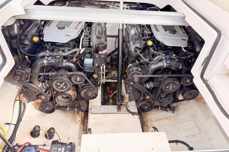 Slide: The Image of Engine compartment of a 2012 Chaparral 327 SSX boat, showcasing dual engines and mechanical components. - 21
