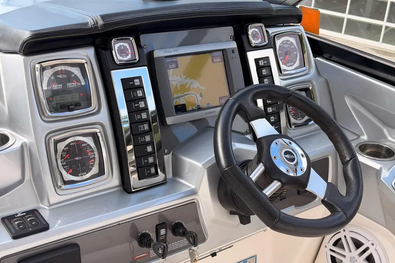 Slide: The Image of Dashboard of 2012 Chaparral 327 SSX boat with steering wheel and navigation system. - 25