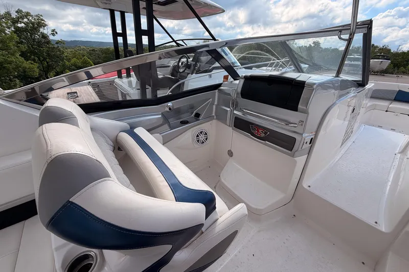 Slide: The Image of Interior view of 2012 Chaparral 327 SSX boat, featuring sleek seating and modern dashboard. - 29