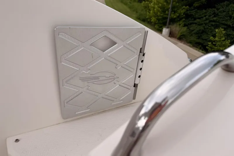 Slide: The Image of 2012 Chaparral 327 SSX boat detail with metal panel and railing. - 15