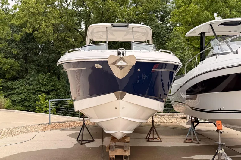 Slide: The Image of 2012 Chaparral 327 SSX boat on stands, surrounded by trees. - 4