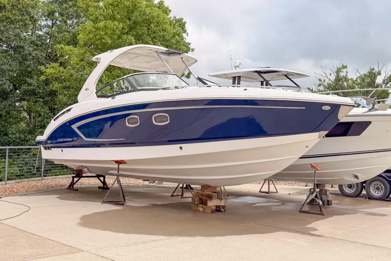 Slide: The Image of 2012 Chaparral 327 SSX boat on display, featuring sleek blue and white design. - 3