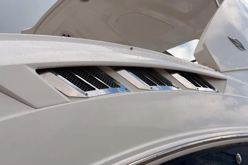 Slide: The Image of Close-up of 2012 Chaparral 327 SSX boat with sleek chrome vents and raindrops. - 27