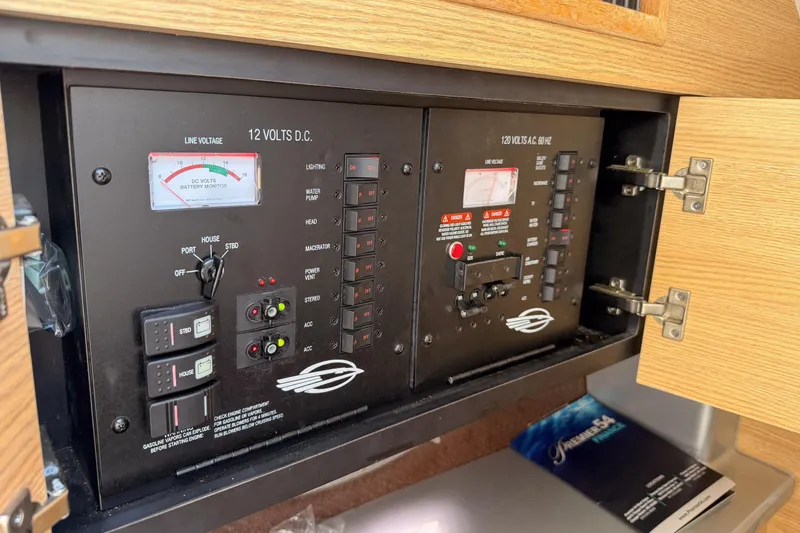 Slide: The Image of Electrical control panel on a 2012 Chaparral 327 SSX boat, featuring voltage meters and switches. - 22